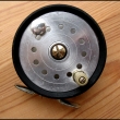 Rousek mu�ka�sk� navij�k se zadn� brzdou, �ehta�kou, achatinov� vod�c� o�ko,pr�m�r 85 mm, zna�en Rousek na matici brzdy.